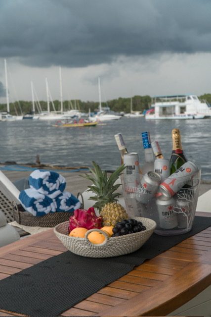 Guests seated on the aft deck of a yacht at dusk with drinks