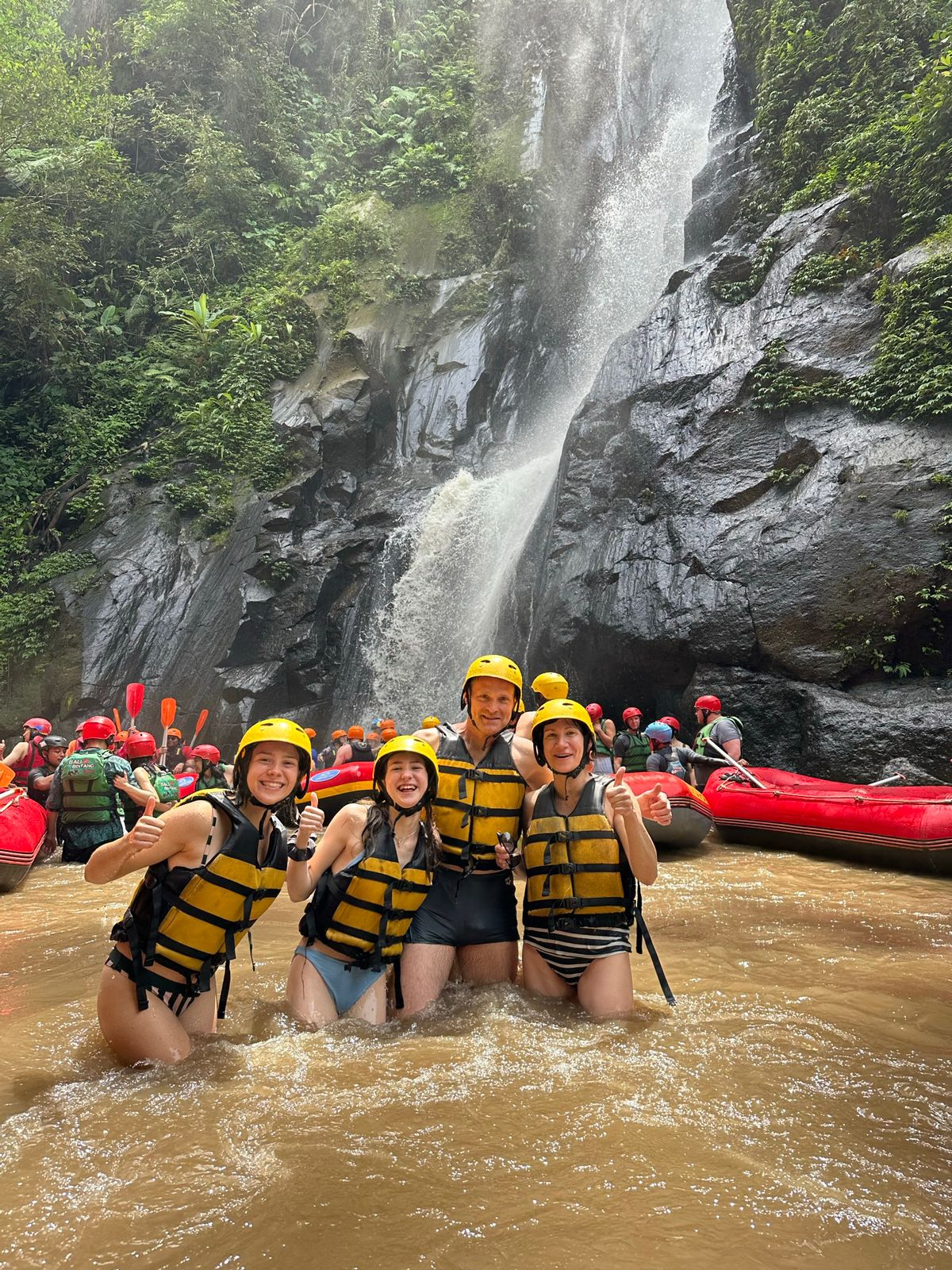 Action shot of rafting team splashing through river chute